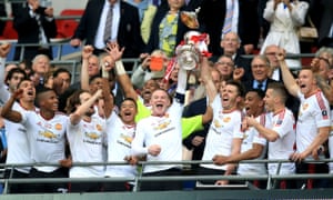 Manchester United’s Wayne Rooney (left) and Michael Carrick (right) lift the FA Cup trophy.