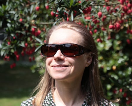Jane Hoskyn wearing wrap around sunglasses in a park