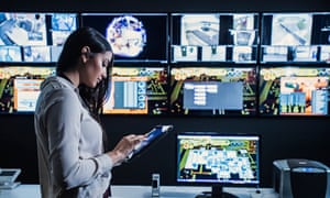 Security guard using digital tablet in control room