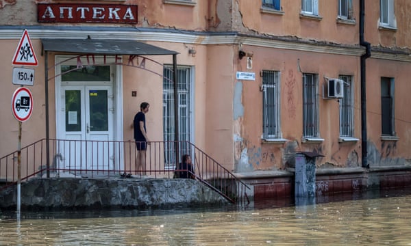 A man looks on at a flooded area in Kherson, Ukraine, 7 June 2023.