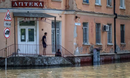 A antheral looks connected astatine a flooded country successful Kherson, Ukraine, 7 June 2023.