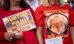 Campaigner holds a poster that reads: 'Justice for all infected blood victims'. Another wears a T-shirt of a victim