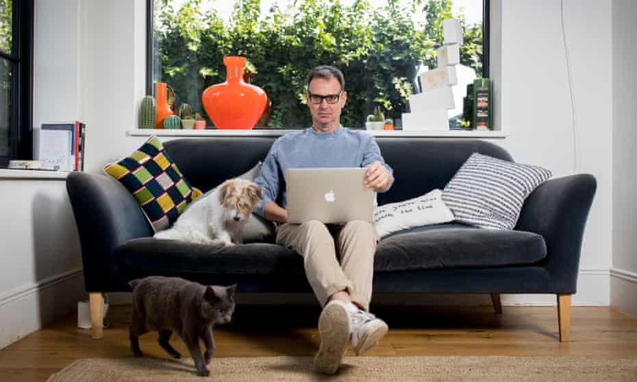 Tim Dowling at home in west London with his dog Nelly and cat James, October 2020.