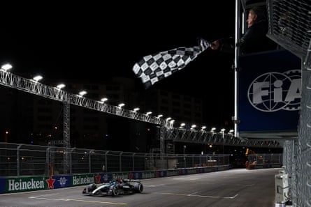 Race winner George Russell takes the chequered flag.