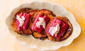 Three banana pancakes topped with rhubarb on a platter