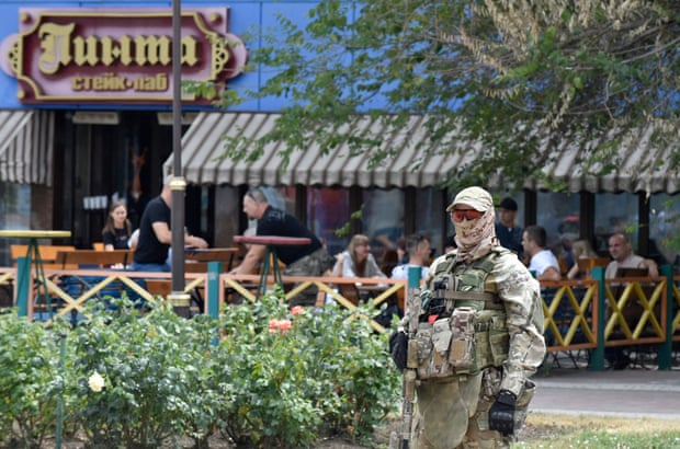 A Russian serviceman stands guard in Melitopol, Zaporizhzhia region