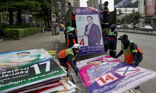 Workers load campaign billboards displayed to promote candidates for last month’s general election into a truck in Bangkok, Thailand.