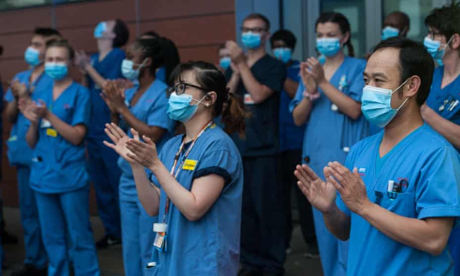 Local people and NHS workers applaud key workers at Royal London Hospital in East London
