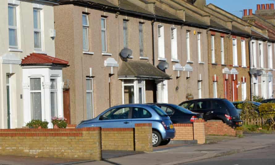 Cars parked in drives of terrace homes.