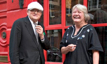 Lynn Barber and David Hockney smoking outside a building