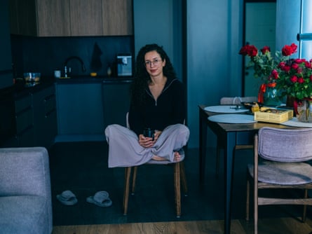 Mariia Shuvalova sitting cross-legged in her Kyiv apartment.