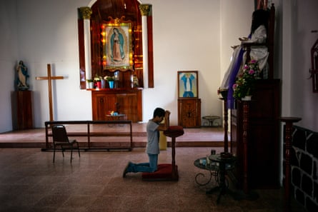 A migrant prays at a church in the town of Huixtla, Chiapas state, Mexico.
