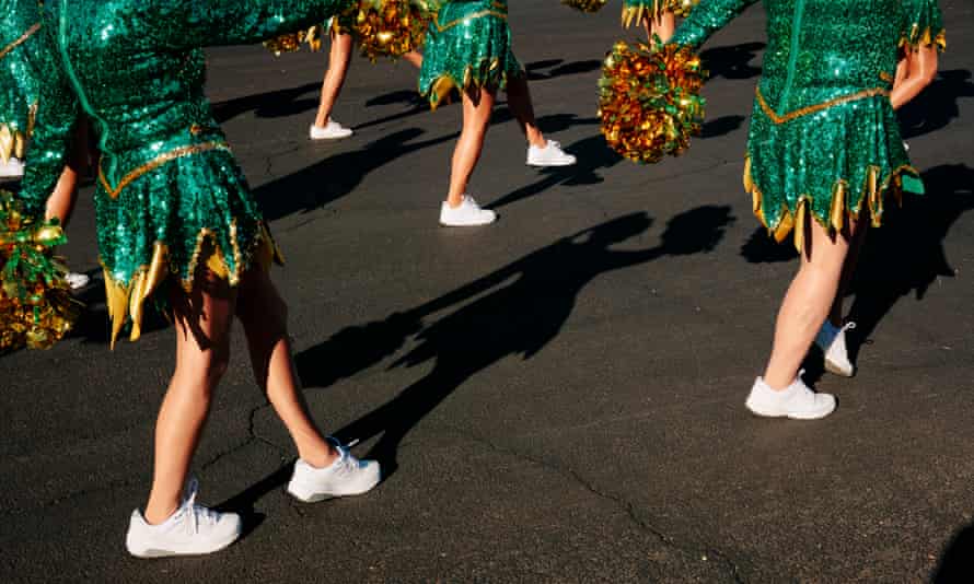 The Sun City Poms march down the street in formation in the Christmas in the Park holiday parade in Litchfield Park, Arizona December 11, 2021