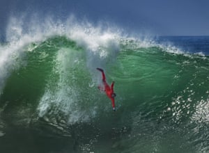 A bodysurfer drops down into a wave at the Wedge in California