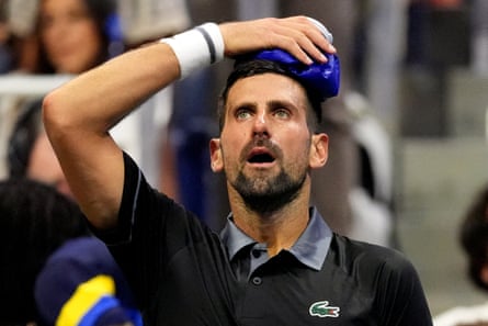 Djokovic tries to cool down during a break in play.