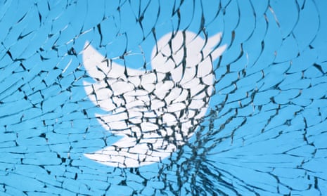 Twitter logo seen through broken glass