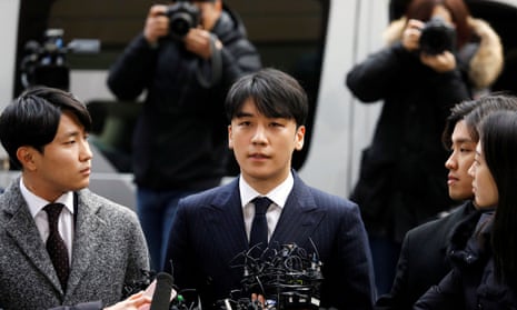 Big Bang member Seungri, centre, who admitted to secretly filming himself with at least ten women.