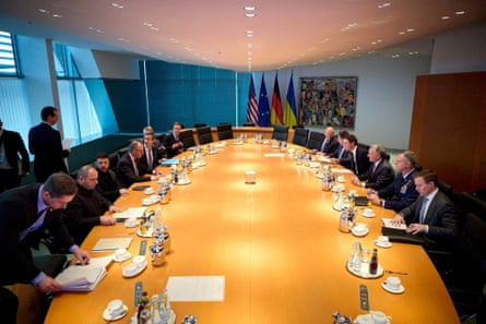 European and US leaders sit around a large oval-shaped table.