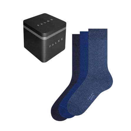 Three socks in black, petrol blue, and a muted navy are shown next to the branded Falke box the socks are packaged in.