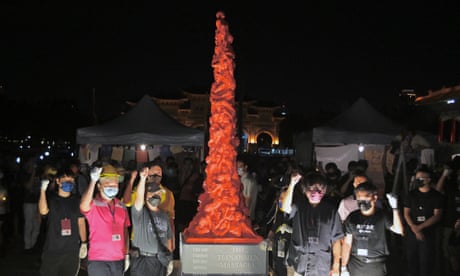 People chant slogans next to a replica Pillar of Shame during a vigil to mark the anniversary of the 1989 Tiananmen Square crackdown