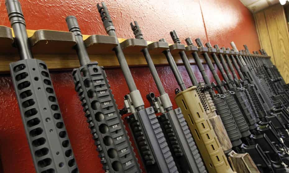 A row of different AR-15 style rifles are displayed for sale in Aurora, Colorado. 