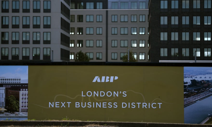 Logos are pictured on builders’ hoardings outside a joint business development at the redeveloped Royal Albert Dock