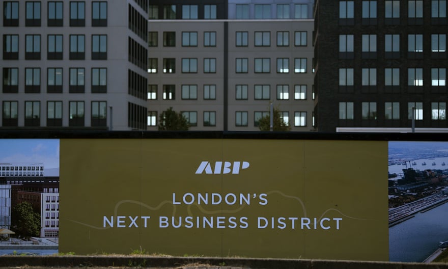 Logos have been painted on builders' stock outside a joint business development at the rebuilt Royal Albert Dock.