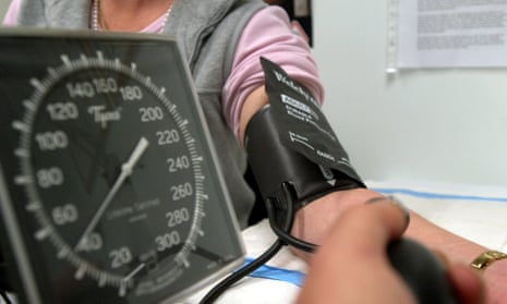 A doctor checks the blood pressure of a patient