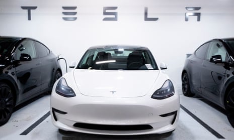 A Tesla Model 3 vehicle, flanked by two Model Y vehicles.