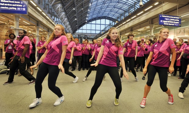 Olympic volunteers dance during a flash-mob at the Eurostar terminal in St Pancras station, London