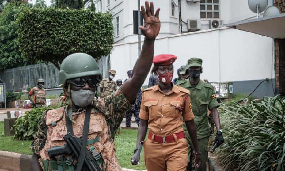 Officers patrol in a street in a Kampala suburb before the presidential election results are announced.