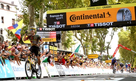 Jumbo-Visma’s Christophe Laporte celebrates as he crosses the finish line to win the 19th stage