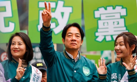 Lai Ching-te makes a V for Victory sign with his raised fingers at a campaign rally