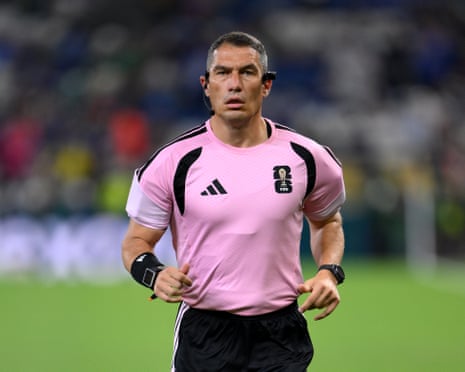 Referee Istvan Kovacs warms up before the match