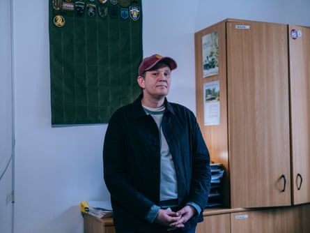 Oleksandr at the rehab clinic, wearing a baseball cap and dark blue jacket