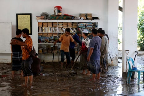Residents clean up their houses in a flood-affected village in the Meureudu area, Pidie Jaya Aceh, Indonesia.