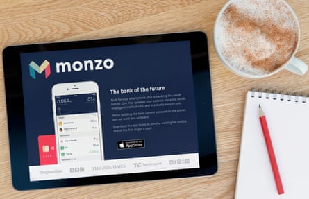 The Monzo website on an iPad, shot against a wooden table top background