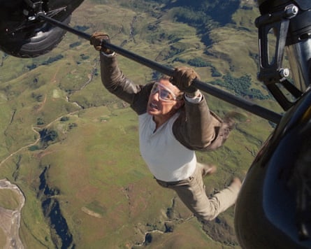 Tom Cruise hangs from a plane in a Mission Impossible film