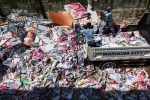 City workers dump election campaign posters at a sorting facility
