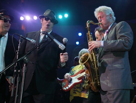 Former US president Bill Clinton performs a saxaphone solo with Dan Aykroyd of The Blues Brothers in 2002.