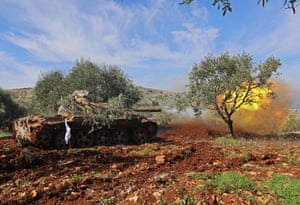 Turkish-backed Syrian rebel fighters fire from the town of Salwah, less than 10km from the border between Syria and Turkey, towards Kurdish forces from the People’s Protection Units (YPG) in the region of Afrin