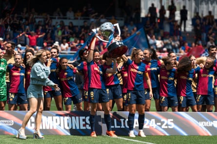 Alexia Putellas and Marta Torrejón lift the league trophy on the final day of the season at Estadi Johan Cruyff