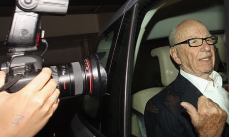 Camera pointed at Murdoch in back of car