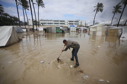 A man in a flooded campsite.
