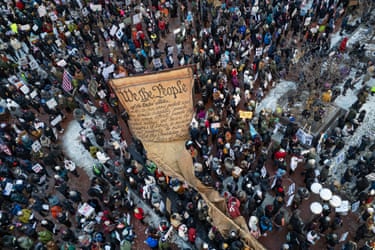 Aerial photograph of the giant scroll and a parade of protesters
