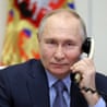 Russian president Vladimir Putin in a suit on the phone.