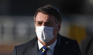Brazilian President Jair Bolsonaro wears a face mask as he arrives at the flag-raising ceremony before a ministerial meeting at the Alvorada Palace in Brasilia, Brazil, in May 2020.