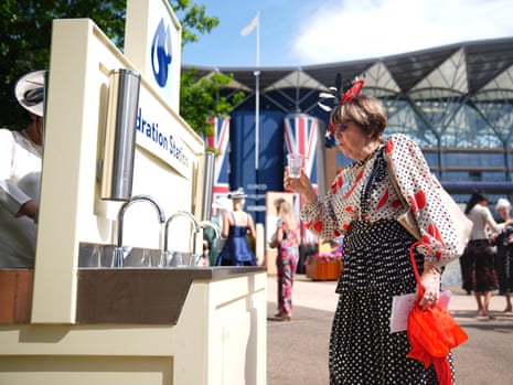 A racegoer makes use of the Hydration Station on what is going to be a very warm day at Royal Ascot.