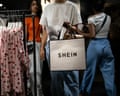 A customer carries a Shein brand bag after shopping at a pop-up store