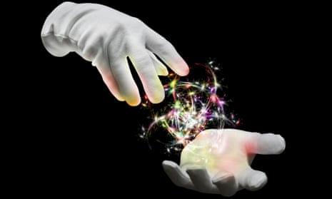 Hands of a magician with coloured lights
